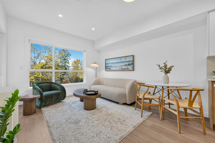 Dining area and living room with windows onto the trees