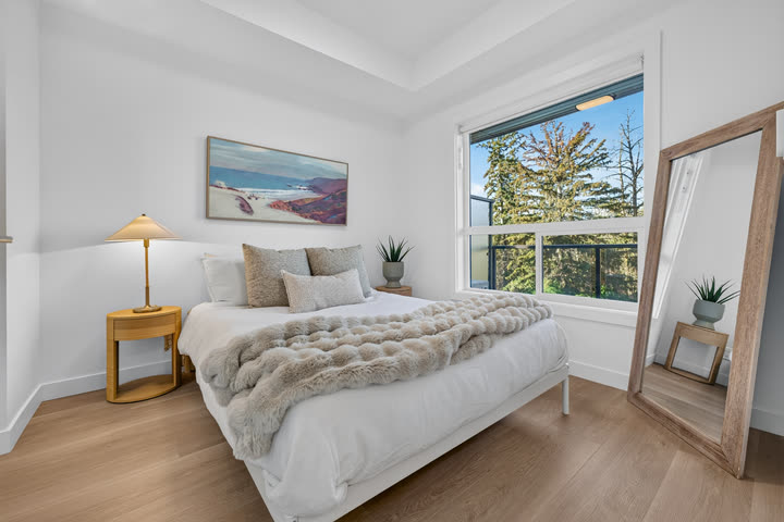 Primary bedroom with a large window onto the ravine
