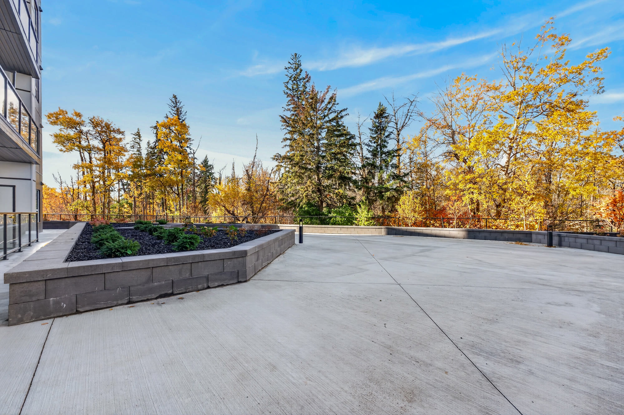 The Sanctuary courtyard terrace with planters, backing onto the ravine